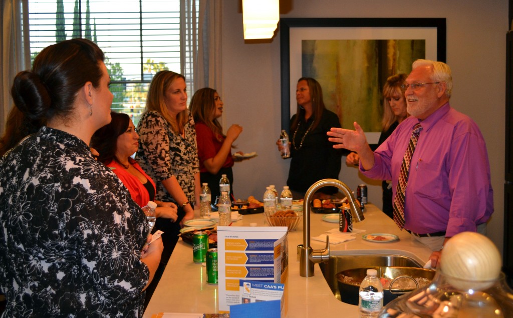 Photo by Matt Buck Moreno Valley City Councilman Jeffrey Giba, at right, gestures while talking with attendees at the California Apartment Association Greater Inland Empire's first Moreno Valley town hall reception, held Sept. 24 at Cannon Management’s Overlook at Rancho Belago.
